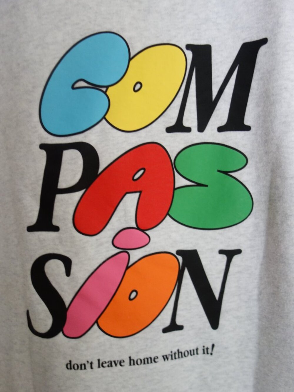 MAYFAIR GROUP Light Gray Hoodie Sweatshirt “Compassion” – One Size